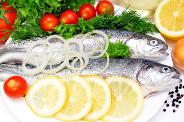 two rainbow trout with lemon and fresh vegetables