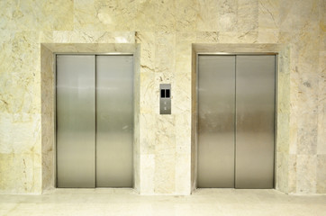 Hallway view of a modern closed elevator..