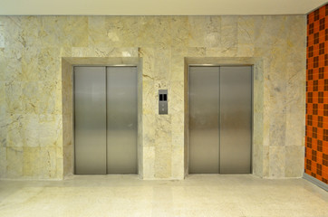 Hallway view of a modern closed elevator..