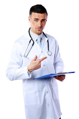 Confident male doctor with clipboard standing