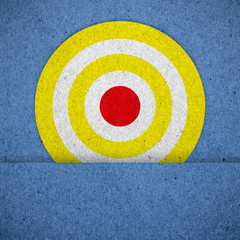 goal ring in archery target on blue paper texture