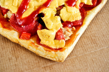 Tasty pizza with cheese, tomatoes and meat in a box