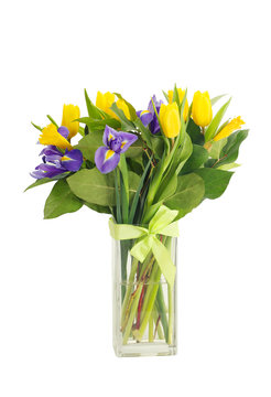 bouquet of tulips and irises in glass vase isolated on white