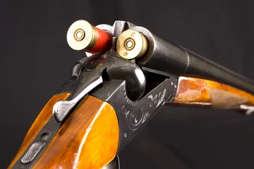 Poster Chasser Opened double-barrelled hunting gun with two cartridges