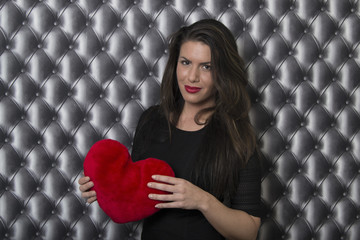 Woman holding a red heart gift for Valentine's day