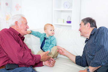 Obraz premium Two grandfather and their grandson play