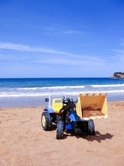 A dump truck toy on the beach