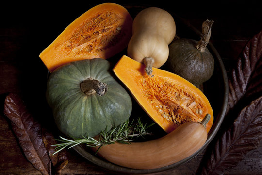variety of pumpkins with rustic autumnal background