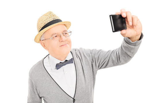 Senior gentleman taking a selfie with cell phone