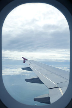 Fototapeta View from a jet plane window high on the blue skies