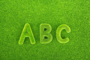 Alphabet letters ABC made from grass with grass background