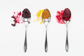 Mixed berry, apricot and sour cherry jam on spoons