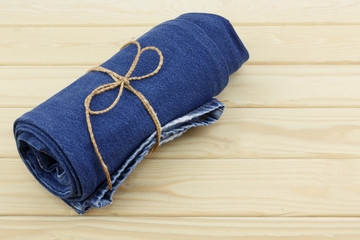 Blue jeans on wooden background