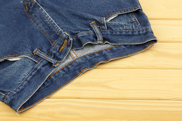 Blue jeans on wooden background