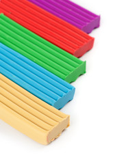 Obraz premium pieces of colored plasticine on a white background