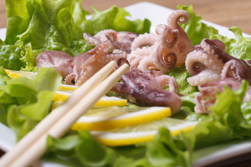 little octopus with lemon and chopsticks horizontal