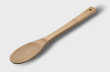 Wooden spoon on light gray background