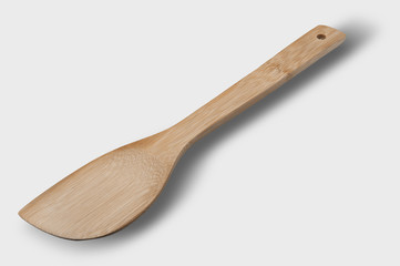 Wooden spoon on light gray background