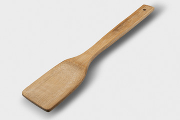 Wooden spoon on light gray background