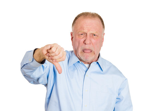 Old, unhappy, displeased man giving  thumbs down