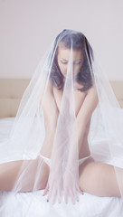 Portrait of shy beautiful bride posing topless