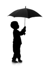 Silhouette of little boy with umbrella