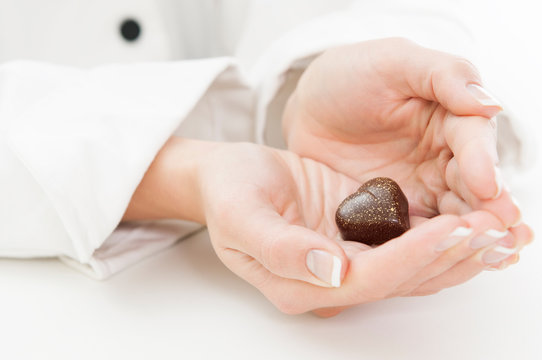 Women chef holding heart shaped Chocolate Candy