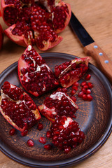 Ripe pomegranates on table close-up