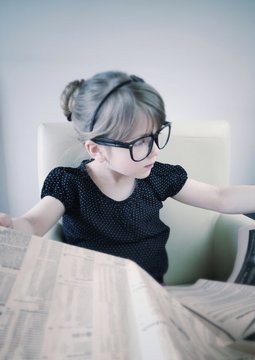 Child Reading Newspaper