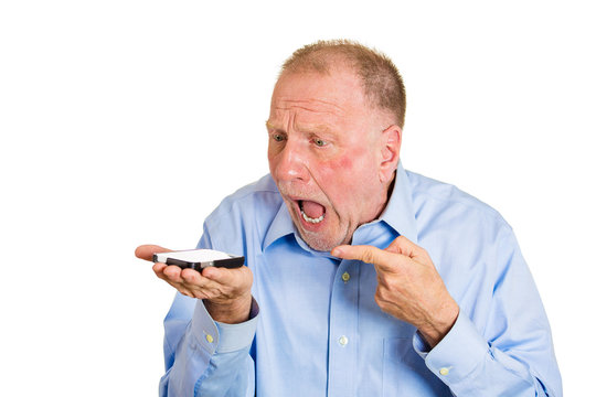 Angry senior man screaming on cell phone, white background 