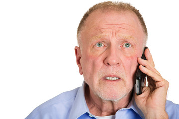 Depressed sad old man receiving bad news on phone