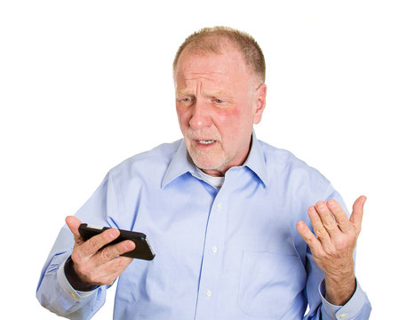 Old man receiving bad news on cellphone device