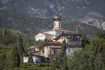 Orthodox church in the village among Crimean mountains.