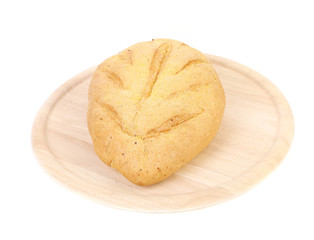 Freshly baked loaf of cornbread on platter.