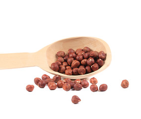 Spoon with hazelnuts close-up.