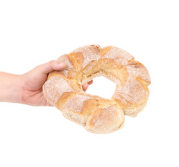 Hand holding round bread.