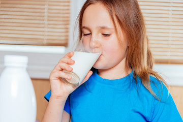 Little girl drinks milk