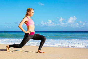 Fototapeta na wymiar Athletic Fitness Woman Stretching At the Beach,