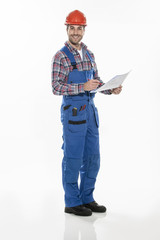 a craftsman in workwear clothing with an hardhat is examining bl