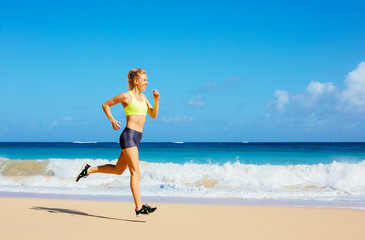 Fototapeta na wymiar Athletic Young Woman Running on the Beach