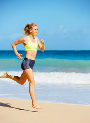 Athletic Woman Running on the Beach