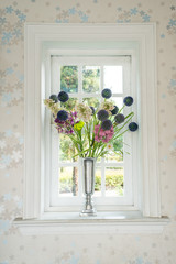 Vase with a flower on the windowsill country house
