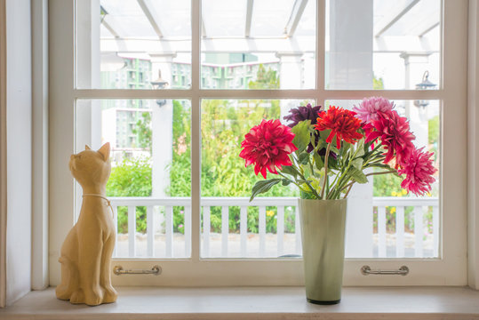 Vase  With A Flower And Cat Doll On The Windowsill Country House