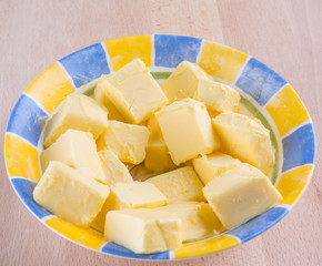 A group of melting butter in a bowl on a pastry board