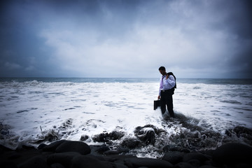 Businessman At Stormy Ocean