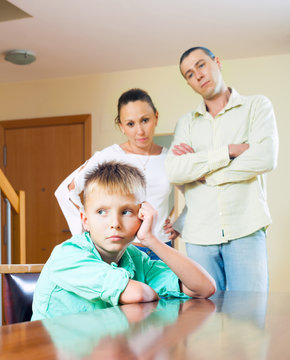 Parents scolding teenage child in home