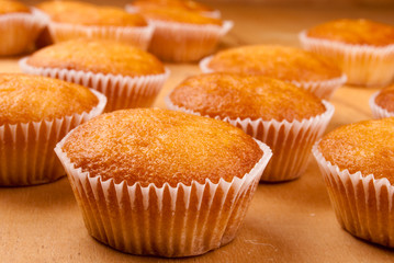 Close-up of cupcakes on wooden board.
