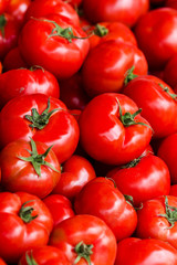 Group of fresh tomatoes background. Ripe red tomatoes on a marke