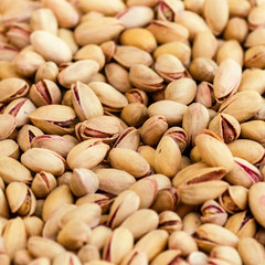 Pistachios background close up. Pistachio Nuts Pile on a market.