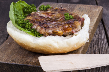 hamburger on a bun with lettuce